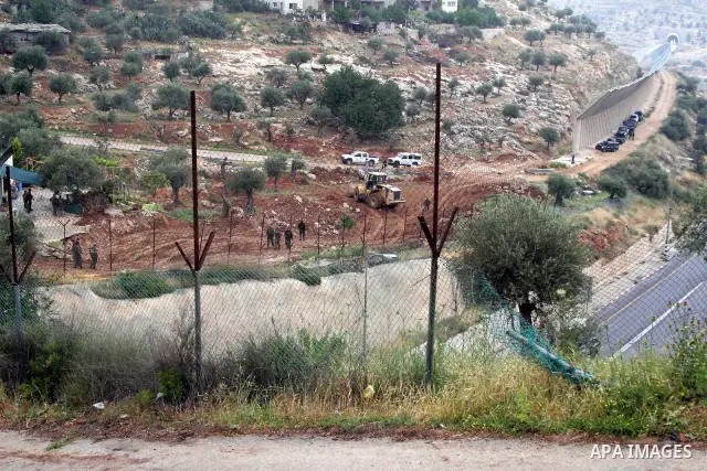 Israeli soldiers stand guard during a demonstration by foreign activists and Palestinians against the extension of Israel's controversial separation barrier in the Palestinian West Bank village of Beit Jala, south of Jer...