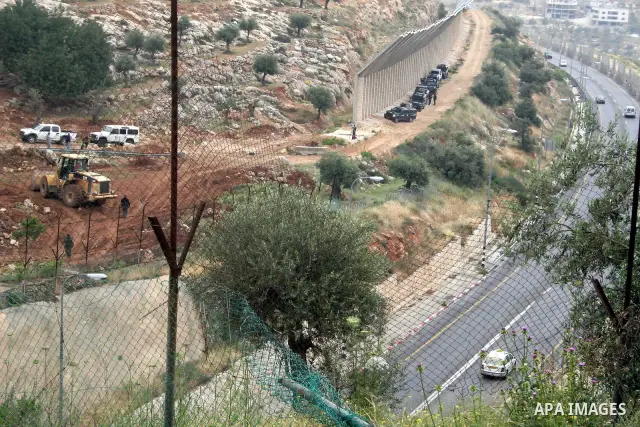 Israeli soldiers stand guard during a demonstration by foreign activists and Palestinians against the extension of Israel's controversial separation barrier in the Palestinian West Bank village of Beit Jala, south of Jer...