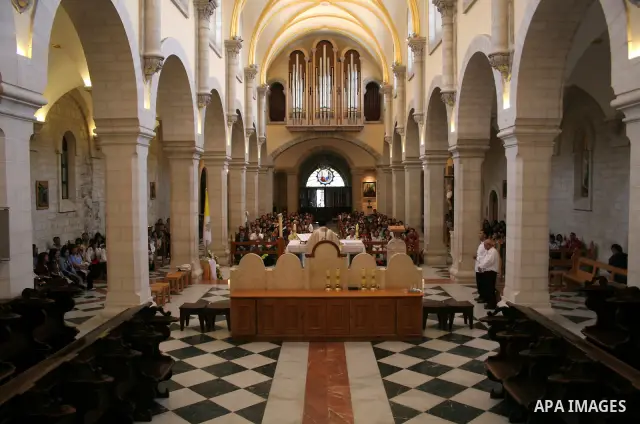 Palestinian worshippers take part in a prayer and march at the Church of St. Catherine, which is connected to the Church of the Nativity, the traditionally accepted birhtplace of Jesus Christ, in the West Bank town of Be...