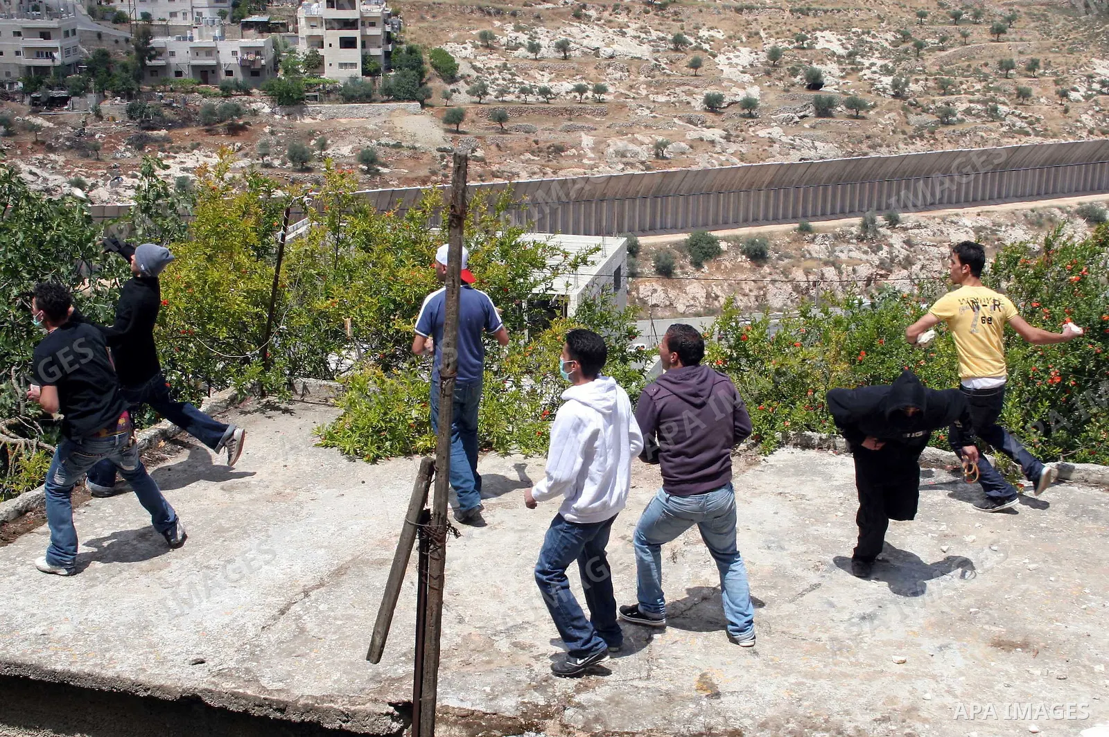Palestinian protestors hurl stones towards Israeli troops during clashes with Palestinian stone-throwers during a protest near the West Bank village of Beit Jala near Bethlehem on May 02, 2010. Photo by Najeh Hashlamoun