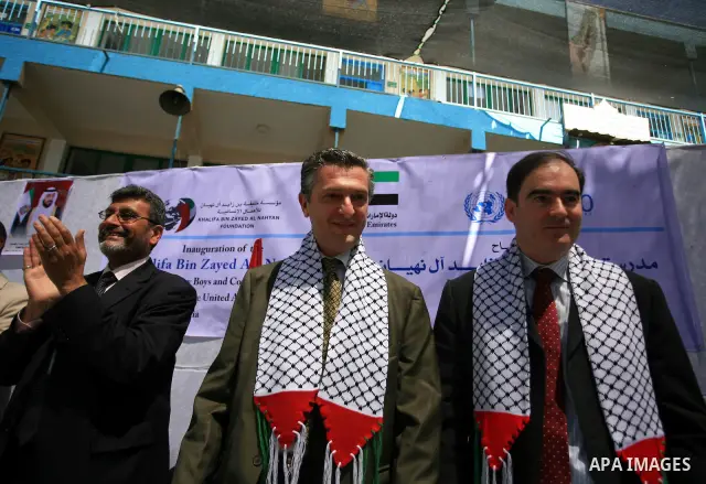 Members of the UN Relief and Works Agency (UNRWA) attend the opening of a school in Beit Lahia, northern Gaza Strip, which was hit by Israeli fire during its last major military offensive on the impoverished Hamas-ruled...