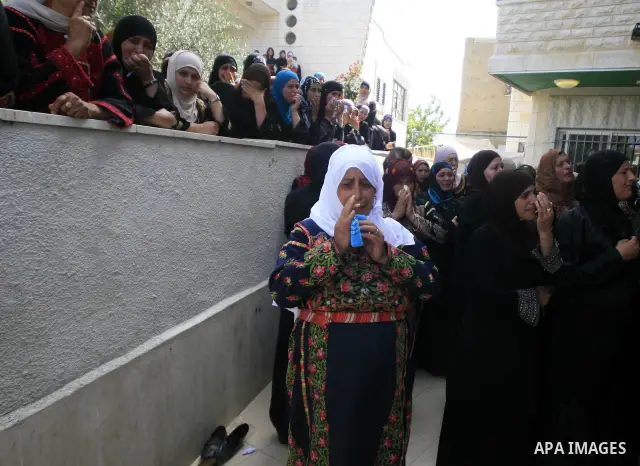 Palestinian women mourn Ayssar Yasser al-Zaben, 16, during his funeral in the West Bank village of Mazra ash Sharqiya, near Ramallah, on May 14, 2010, An Israeli settler shot dead the 16-year-old Palestinian youth after...