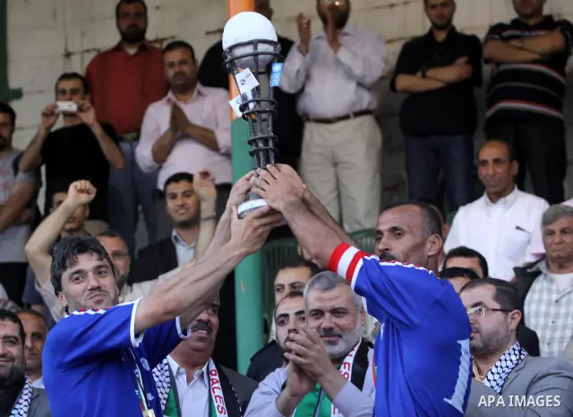 Palestinian players of France celebrate after the winning in a soccer match with Jordan during the final match of Gaza's version of the World Cup in Gaza City on May 15,2010. The Gaza Strip kicked off its own version of...