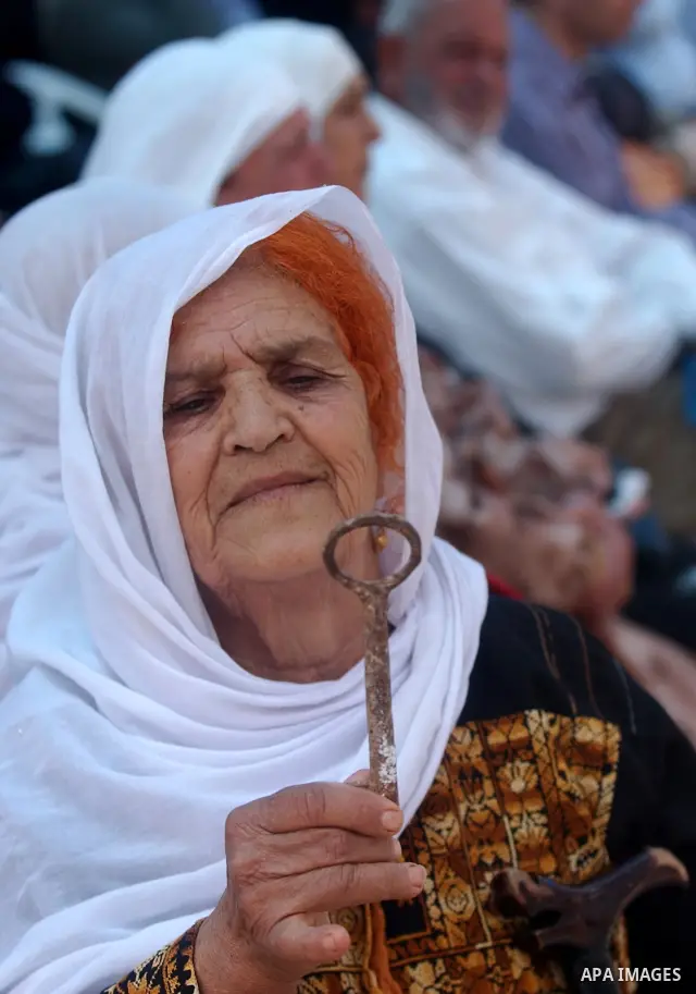 A Palestinian woman holds up a symbolic key during a rally marking the "Nakba" (Catastrophe) in the West Bank city of Salfit on May 19,2010. Photo by Wagdi Eshtayah