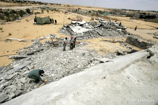 Palestinians inspect their belongings after their house was demolished by Hamas security forces in Rafah in the southern Gaza Strip on May 19, 2010. Hamas Islamists ruling the Gaza Strip have been demolishing Palestinian...
