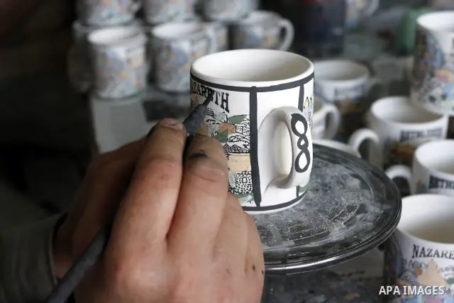Palestinian worker decorates and paints on the ceramics in the West Bank city of Hebron on May 20, 2010. This factory creates artifacts and Judaic made of glass and ceramics . these kinds of products are main products th...