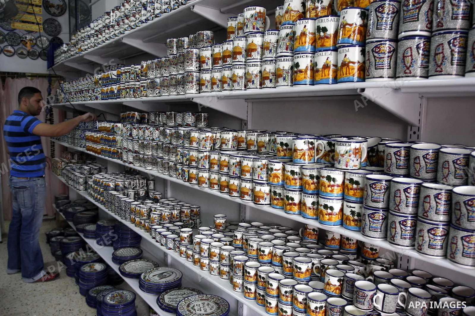 Palestinian worker decorates and paints on the ceramics in the West Bank city of Hebron on May 20, 2010. This factory creates artifacts and Judaic made of glass and ceramics . these kinds of products are main products th...