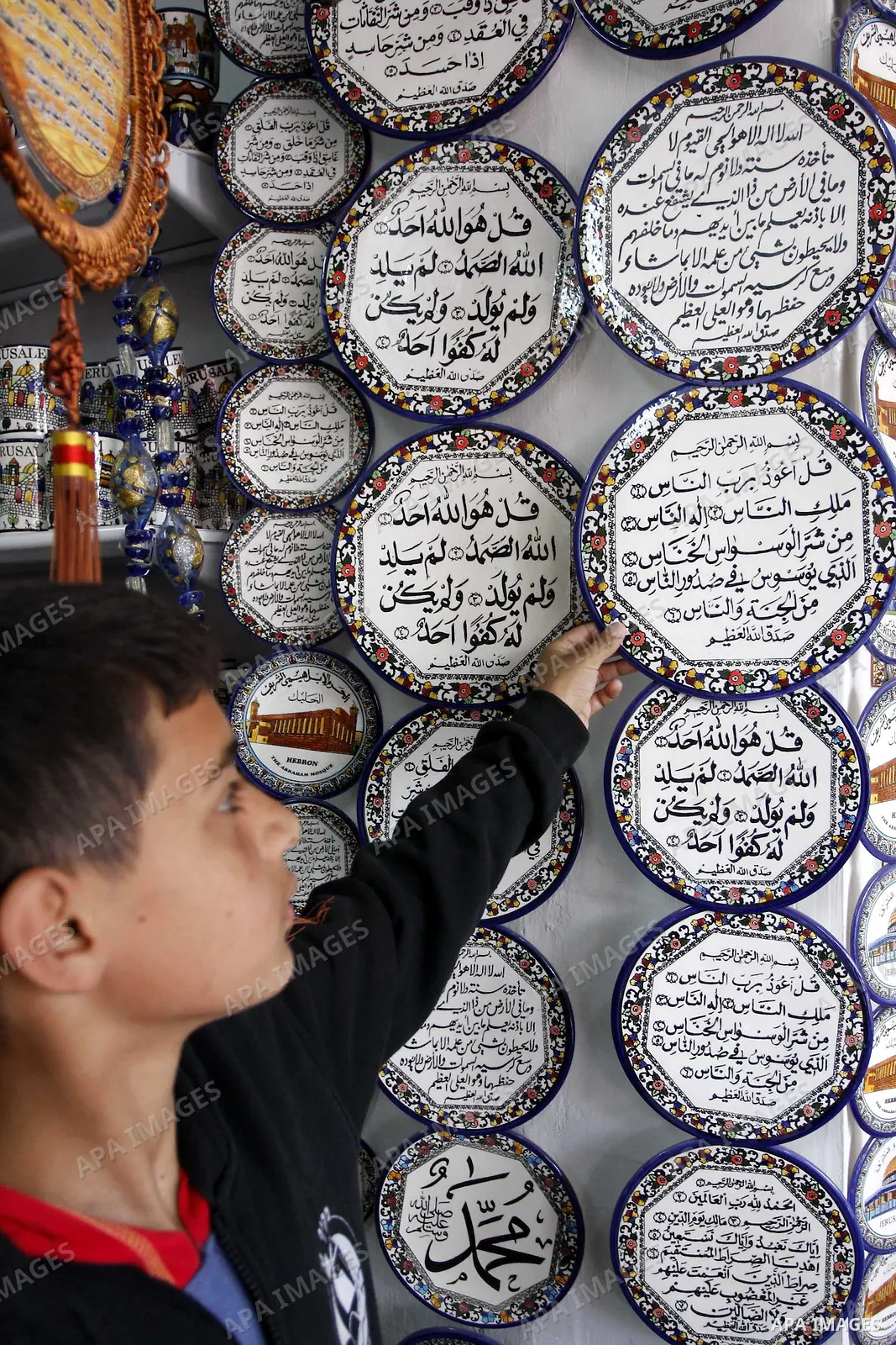 Palestinian worker decorates and paints on the ceramics in the West Bank city of Hebron on May 20, 2010. This factory creates artifacts and Judaic made of glass and ceramics . these kinds of products are main products th...
