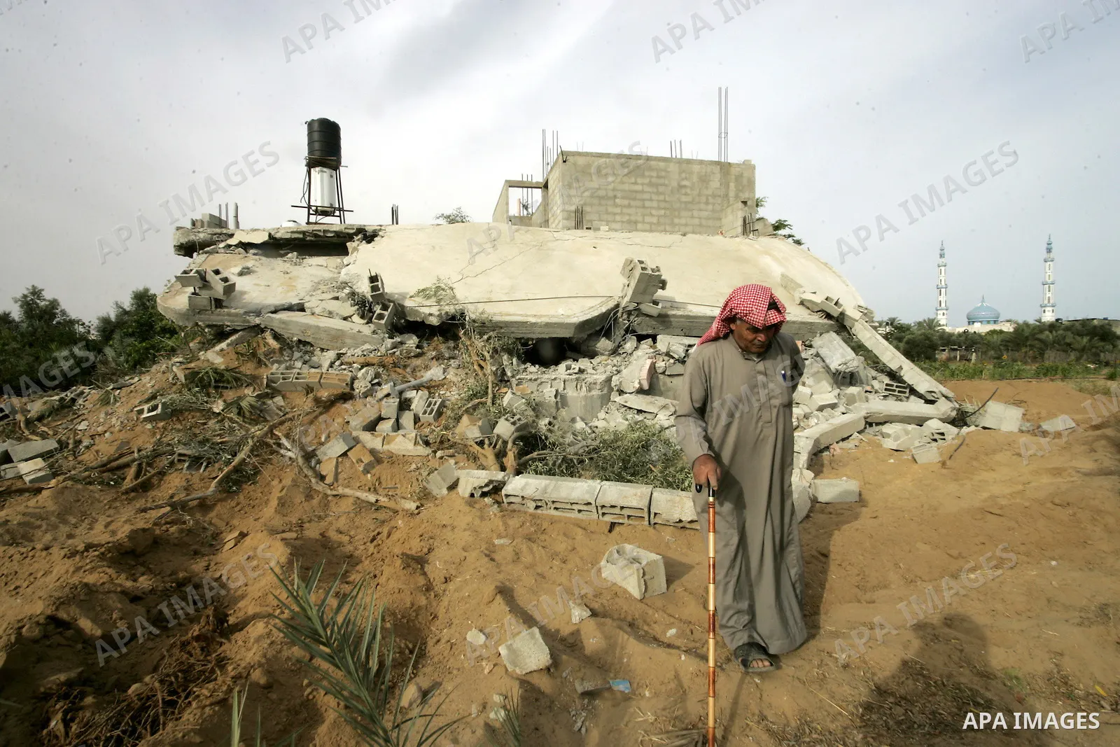 Palestinian man inspects his destroyed house after an Israeli forces incursion in khan-Younis, southern Gaza Strip on May 22, 2010. Two Palestinians were killed Friday afternoon during an exchange of fire with Israeli so...