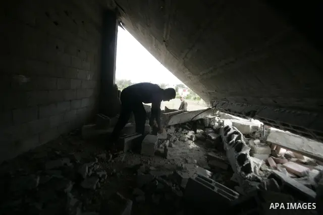 A Palestinian man inspects his destroyed house after an Israeli forces incursion in khan-Younis, southern Gaza Strip on May 22, 2010. Two Palestinians were killed Friday afternoon during an exchange of fire with Israeli...