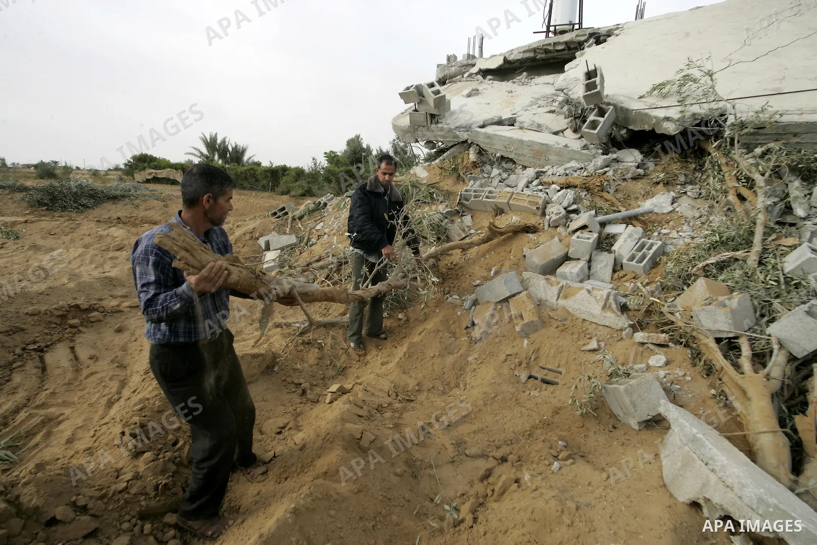 Palestinians inspect their destroyed house after an Israeli forces incursion in khan-Younis, southern Gaza Strip on May 22, 2010. Two Palestinians were killed Friday afternoon during an exchange of fire with Israeli sold...