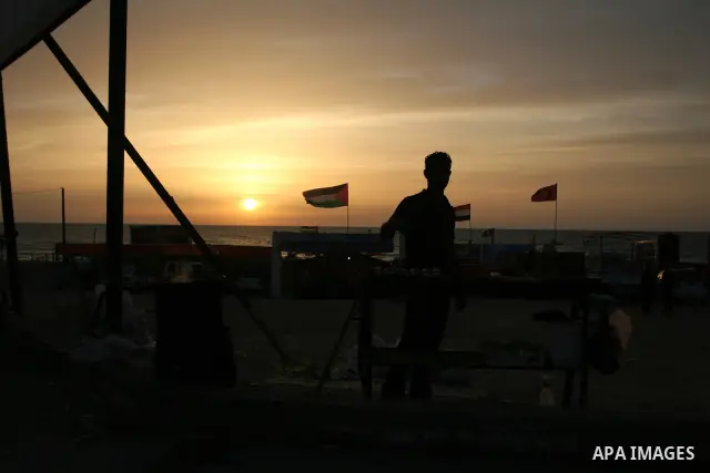 Palestinian youth sells corn on the beach of Gaza City on May 22, 2010. Photo by Ashraf Amra