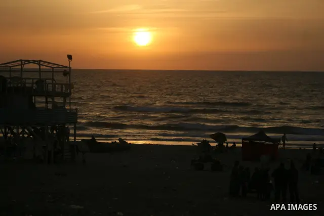 Palestinians sit on the beach of Gaza City on May 22, 2010. Photo by Ashraf Amra