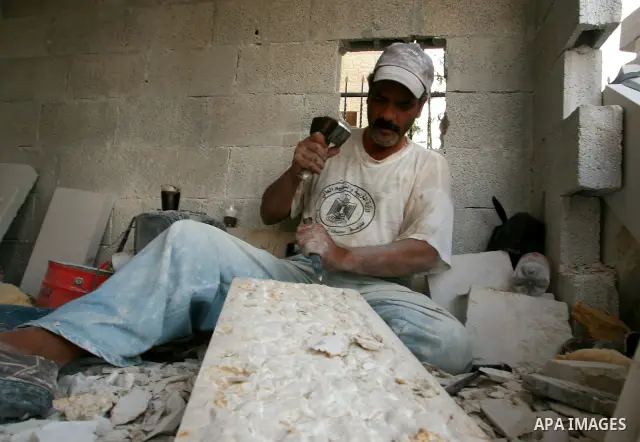 Palestinian man carves marble stones for housing buildings in the West Bank city of Ramallah on May 26, 2010. photo by Eyad Jadallah