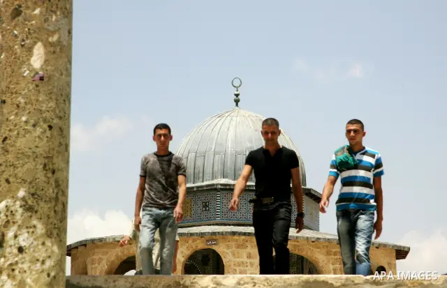 Palestinian Muslim worshippers walk in front of the Dome of Rock after Friday prayers in the Al Aqsa Mosque compound, also known to Jews as the Temple Mount, in Jerusalem's old city on May 28, 2010. Photo by Mahfouz Abu...