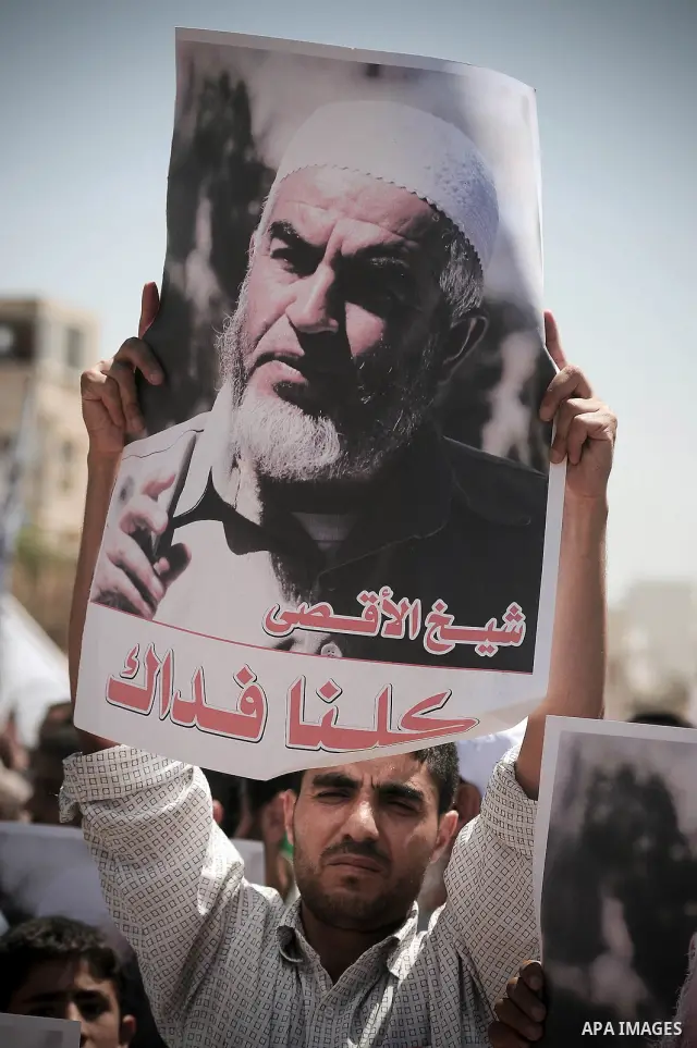 Palestinian Hamas supporters carry pictures of Sheikh Raed Salah during anti-Israeli protest at the port of Gaza City on May 31, 2010. At least 10 activists were killed in an Israeli naval takeover on Monday of a Gaza-bo...