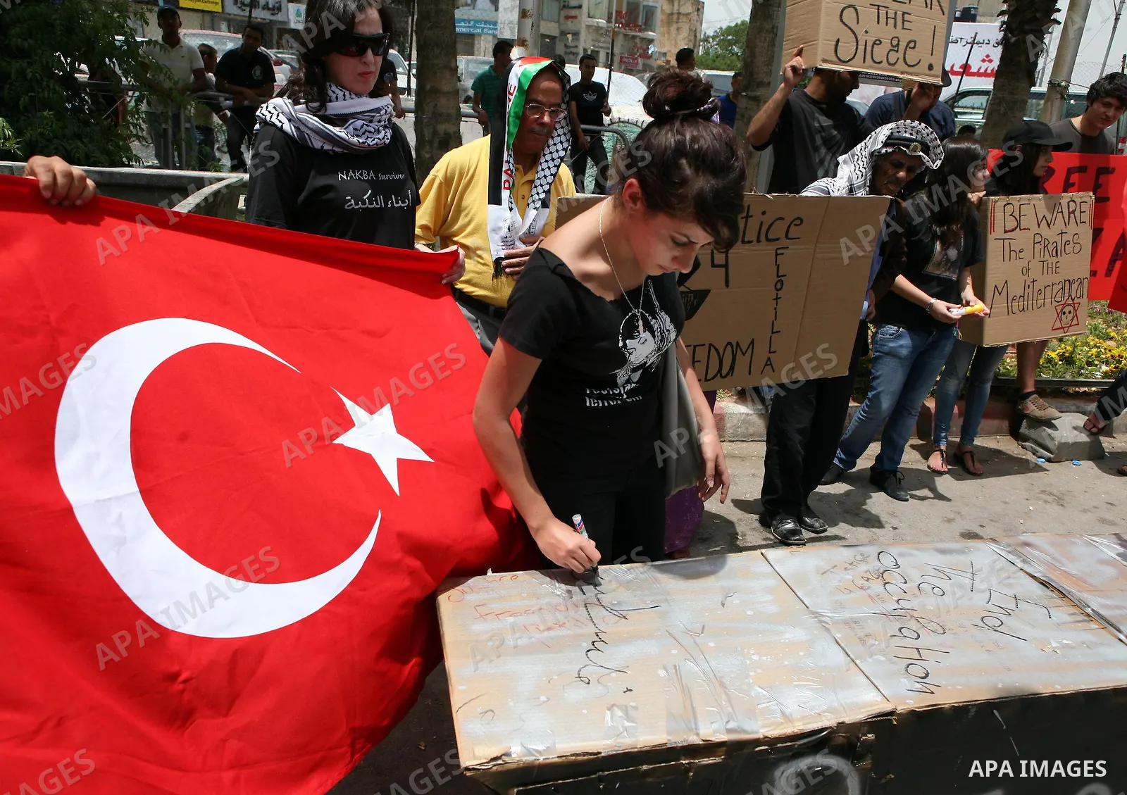 Palestinian and foreign activists take part in a protest in the West Bank city of Ramallah against the storming of Gaza-bound ships, June 1, 2010. Israeli police jailed or deported on Tuesday hundreds of international ac...