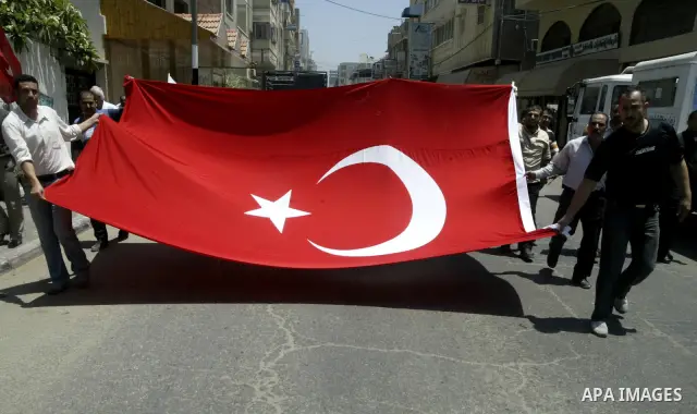 Palestinians wave with Turkish flag during a protest against the storming of Gaza-bound ships in Gaza city on June 1, 2010. Israeli police jailed or deported on Tuesday hundreds of international activists arrested aboard...