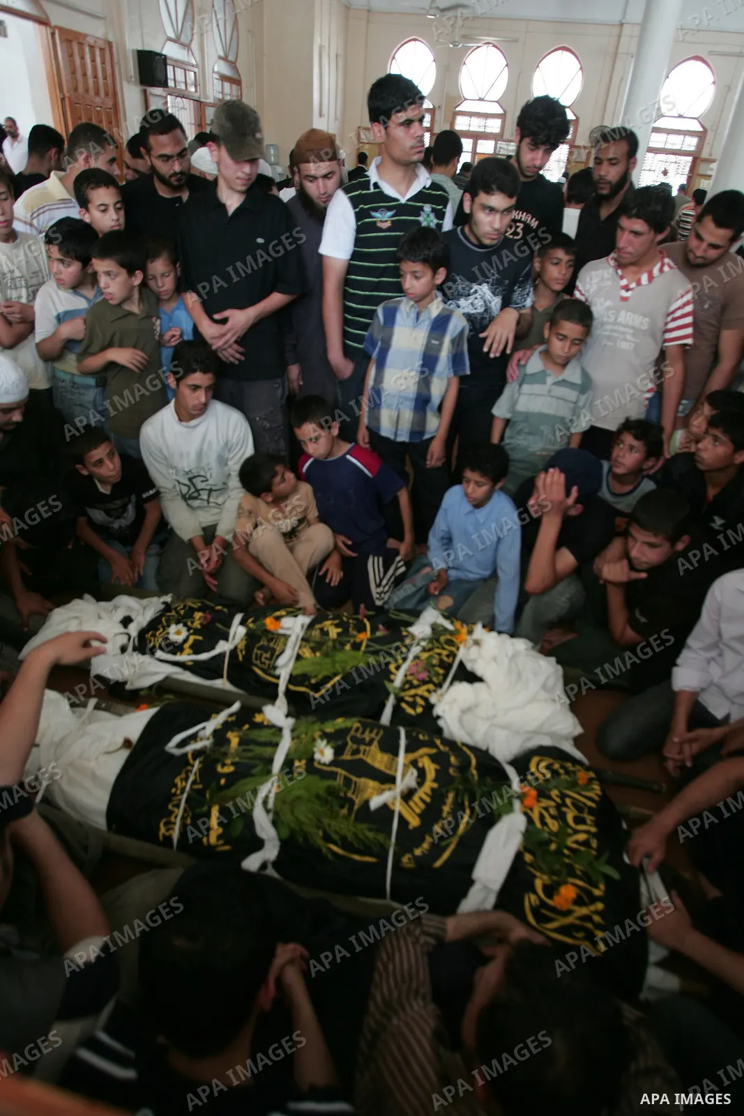 Palestinians mourners look at the bodies of Mohamed Shahoan and Abed Rahman Al-Astal during their funeral in the southern Gaza Strip town of Khan Yunis on June 2, 2010, one day after he was shot dead by Israeli troops as...