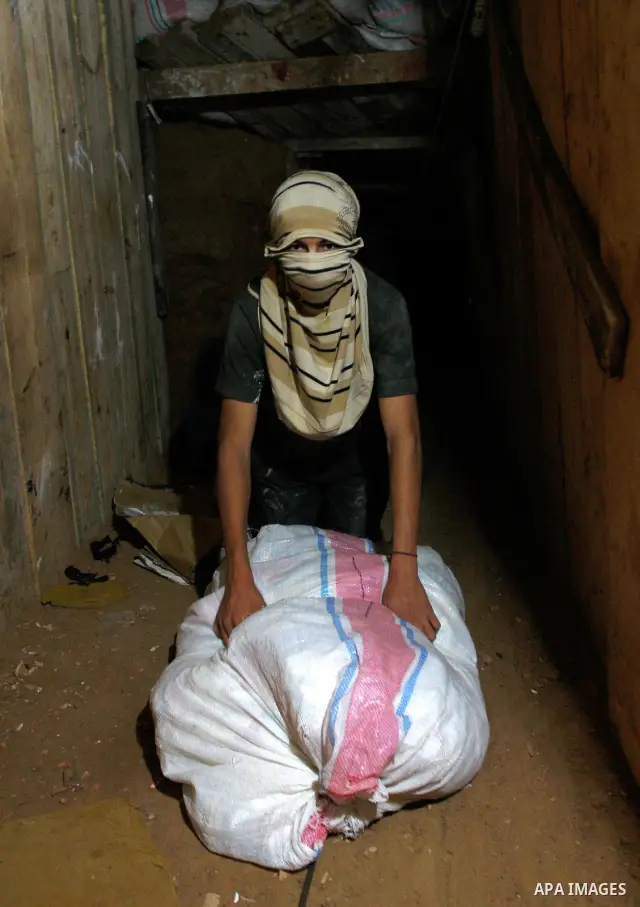 A Palestinian smuggler works in a tunnel which goes beneath the Egyptian-Gaza border at Rafah in the southern Gaza Strip on June 03, 2010, part of a network of tunnels linking Egypt with the Islamist Hamas-ruled enclave...