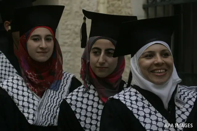 Palestinian students celebrate during their graduation ceremony at Al-Najah University in the West Bank city of Nablus on June 6, 2010. Photo by Wagdi Eshtayah