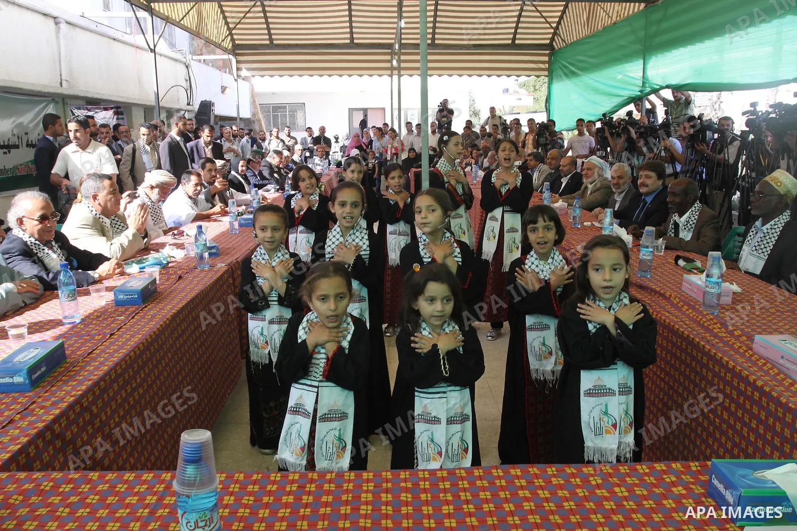Arab Parliament members listen to Palestinian children as they sing in Gaza city on June 6, 2010. Thirty Arab parliament members entered Gaza on Saturday during a visit to Gaza which has been under the Israeli blockade s...