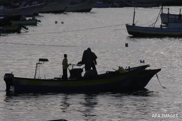 Palestinian fisherman rides his boat during sunset in Gaza sea port on June 7,2010. Photo by Yousef Deeb