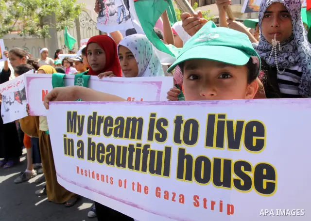 Palestinian children hold banners during a protest calling for the end of the blockade on Gaza, in Gaza city on June 8,2010. Children protest against the Israeli blockade of the seaside territory. Israel imposed a strict...
