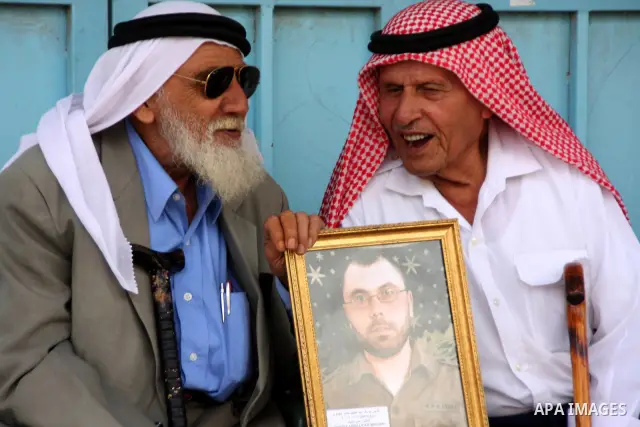Palestinian women hold a picture of relative held in Israeli jails during a protest in the West Bank city of Tulkarem on June 8, 2010. Photo by Wagdi Eshtayah