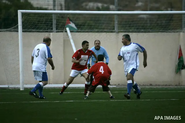 Palestinian politicians, business men and others from different religious communities take part in a soccer match in the northern West Bank town of Nablus on June 9, 2010, two days prior to the start of the World Cup 201...
