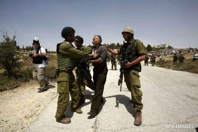 Israeli soldiers detain a Palestinian from the village of Bet In, north of Ramallah, as Palestinians protest against Israeli occupation on June 11, 2010 near the Jewish settlement of Beit El. Photo by Eyad Jadallah