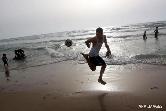 Palestinians enjoy the beach in Gaza City, Friday, June 11, 2010. Gaza has been mired in poverty for decades, but the embargo by Israel deepened the misery, erasing tens of thousands of jobs and preventing repair of dama...
