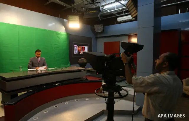 Palestinians work in the offices of the Hamas-run Al-Aqsa TV in Gaza City on June 15, 2010 after Paris decided to take the Gaza station off the air in France within 48 hours because of "incitement to hatred.". Photo by A...