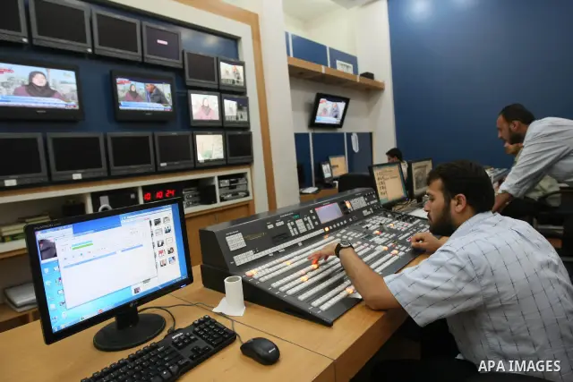 Palestinians work in the offices of the Hamas-run Al-Aqsa TV in Gaza City on June 15, 2010 after Paris decided to take the Gaza station off the air in France within 48 hours because of "incitement to hatred.". Photo by A...