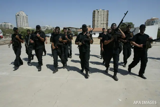 Members of Hamas' security forces demonstrate their skills during a graduation ceremony in Gaza City June 17, 2010. Photo by Ashraf Amra