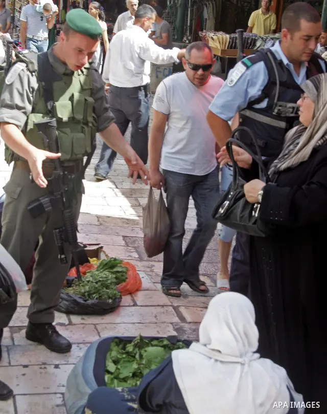 Palestinian women vendors sell their goods in front of Damascus Gate in Jerusalem's Old City on June 19, 2010. Photo by Mahfouz Abu Turk