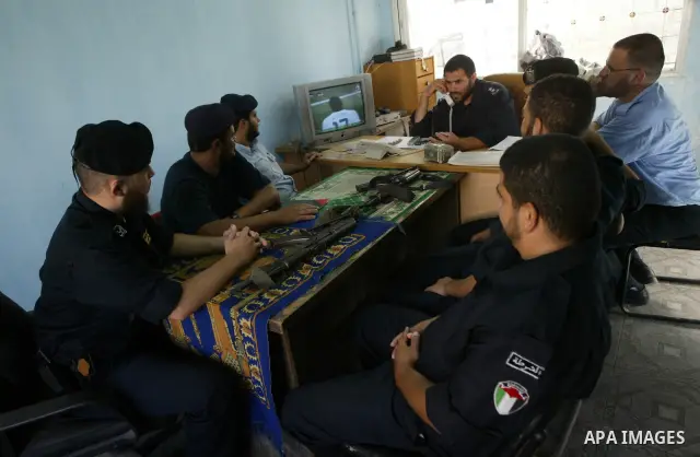 Palestinian Hamas policemen watch the US-Algeria World Cup match at Al-Shegaia police station in Gaza city, Wednesday, June 23, 2010. Photo by Ashraf Amra