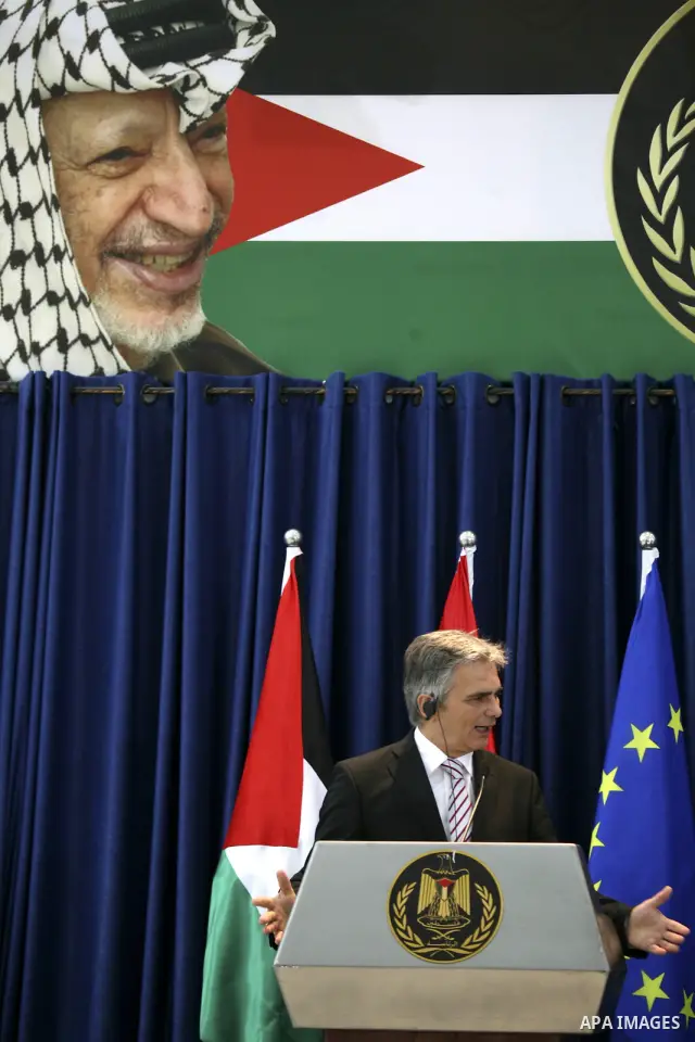 Austrian Chancellor Werner Faymann and Palestinian President Mahmoud Abbas (not seen) hold a joint news conference in the West Bank city of Ramallah on June 24, 2010. Photo by Eyad Jadallah