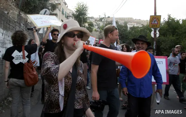 Palestinian and Israeli left-wing activists take part in a demonstration against the Jerusalem Municipality's plan to demolish 22 Arab homes to make way for an archaeological park in east Jerusalem' Al-Bustan area on Jun...