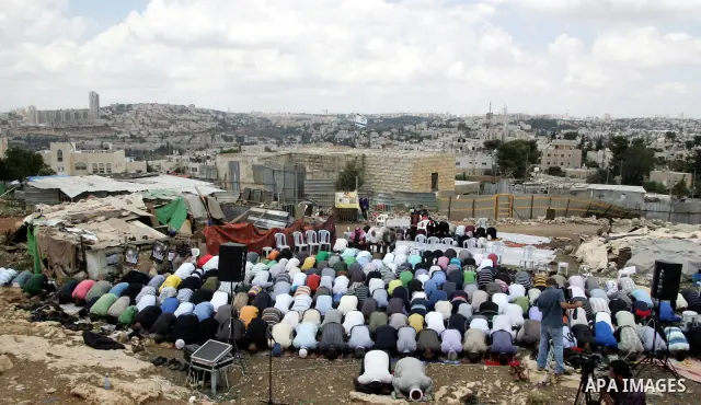 Palestinian protesters perform Friday prayers out on the street in Al-Bustan neighbourhood just outside the old city in Jerusalem June 25, 2010. Israeli municipal authorities moved ahead last week with a plan to raze som...