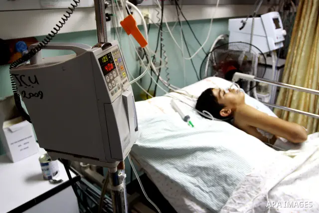 A Palestinian patient receives a treatment in the Intensive care unit at Al-Shefa hospital in Gaza city on June 27,2010, which suffer from power outages as the lack of fuel to Gaza's power station in the city. Photo by M...