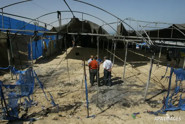 UN Relief and Works Agency (UNRWA) staff members inspect damages at a summer camp which was set on fire overnight by masked gunmen in Deir al-Balah center Gaza strip on June 28, 2010. Photo by Ashraf Amra