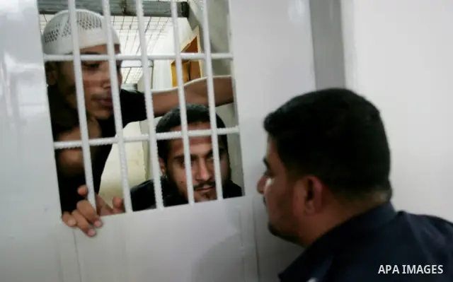 Palestinian police watch inmates in a Hamas-operated new prison in the southern of Gaza strip town of Khan Yunis on June 28,2010.The detention facility was opened after the main prison was destroyed during Israel's 22-da...