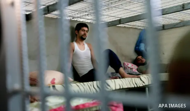 Palestinian inmates look from the door in a Hamas-operated new prison in the southern of Gaza strip town of Khan Yunis on June 28,2010.The detention facility was opened after the main prison was destroyed during Israel's...