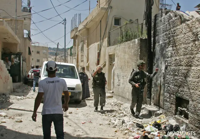 Palestinians inspect the damage in cars by Israeli soldiers after clashes with Palestinian protesters in the Arab east Jerusalem neighbourhood of Silwan on June 28, 2010. Photo by Mahfouz Abu Turk