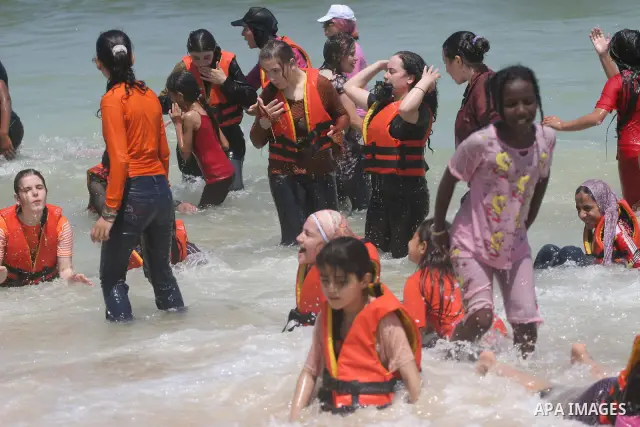 Palestinian girls play at a summer camp run by the United Nations Relief and Works Agency (UNRWA) on the beach in Gaza City on June 28, 2010. UNRWA prepared 38 beach locations and 86 schools for its program entitled ''Su...