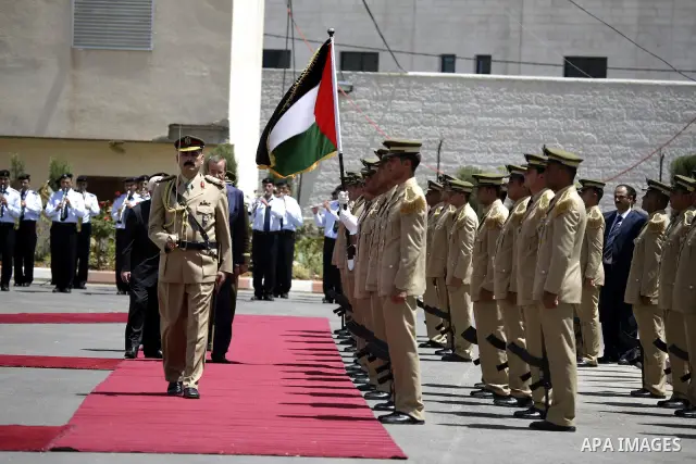 Palestinian President Mahmoud Abbas and Estonian President Toomas Hendrik Ilves during the welcome ceremony, as Ilves arrive to the West Bank city of Ramallah on June 29, 2010. Photo by Eyad Jadallah