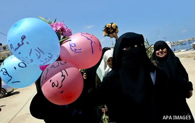 Palestinians take part in a demonstration against Israel's siege on the Gaza Strip at the port in Gaza city on July 1, 2010 to mark one month since Israeli soldiers gunned down nine members of a Gaza-bound aid flotilla....