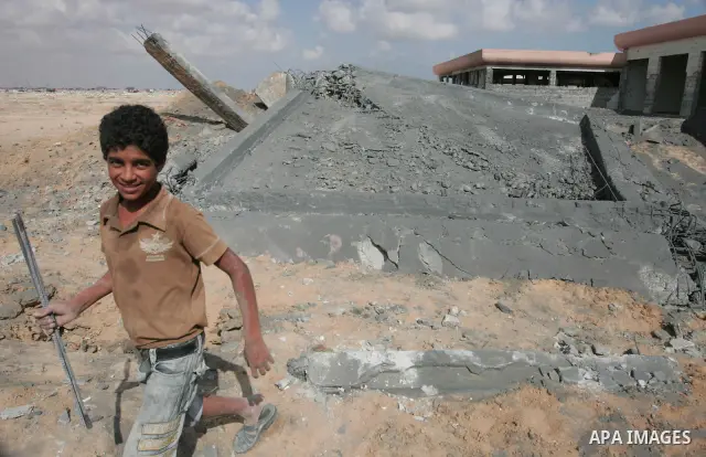 Palestinians inspect destroyed building at an abandoned airport that was hit by an Israeli air strike in the southern Gaza Strip July 1, 2010. Photo by Hatem Omar