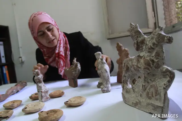 A Palestinian archaeologist displays some of the Canaanite remains that was recently discovered in the Gaza Strip, at the headquarters of the Ministry of Tourism in Gaza City on July 5,2010. Some of these remains return...